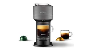 Nespresso coffee machine with two glass mugs of black coffee and coffee pods