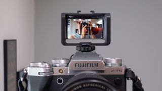 Selfie flip screen bracket mounted on a Fujifilm X-T5 camera