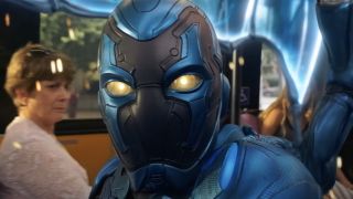 Blue Beetle in the middle of a bus being cut in half