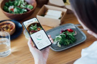 A woman counting calorie in the hope of losing belly fat