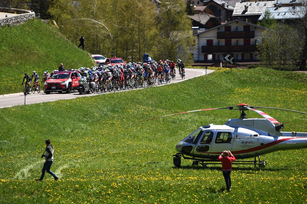 SEGA DI ALA ITALY MAY 26 The peloton at start in Canazei Village during the 104th Giro dItalia 2021 Stage 17 a 193km stage from Canazei to Sega di Ala 1246m Landscape Public Helicopter UCIworldtour girodiitalia Giro on May 26 2021 in Sega di Ala Italy Photo by Tim de WaeleGetty Images