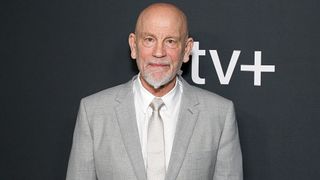 John Malkovich poses for photographs at a screening for Apple TV Plus' The New Look TV show