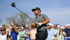 Xander Schauffele hits a driver and watches it off the tee