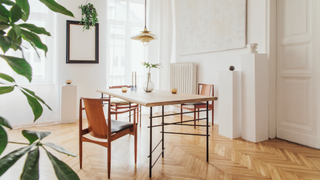 Dining room with chevron-patterned wooden floor