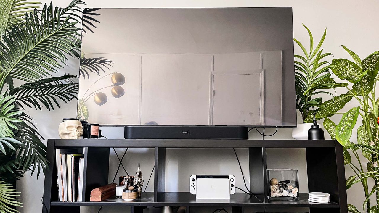 Nintendo switch oled placed on shelf by TV