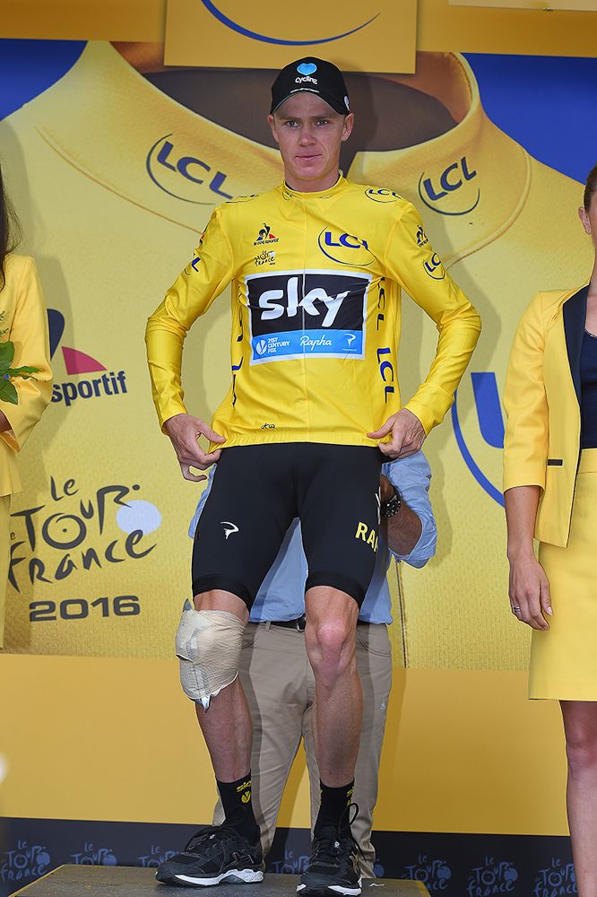 Chris Froome has his knee on ice while on the stage 19 podium