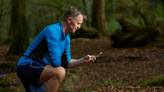 Runner looks down at phone