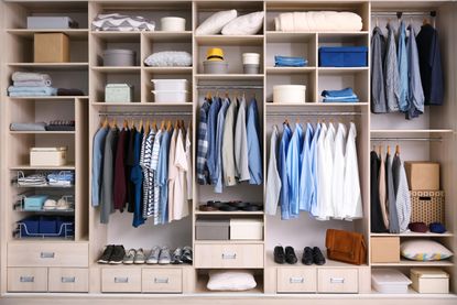 The inside of a closet with different compartments for hanging and folded clothes