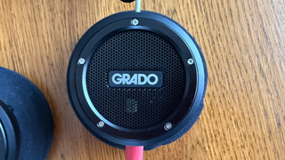 Grado Signature S750 headphones shot from above to show the grado logo. The headphones are on a wooden surface