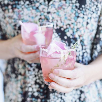 Woman holding two cocktails