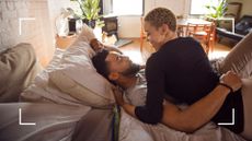 Couple lying romantic in bed looking into each other's eyes, representing yoga sex positions