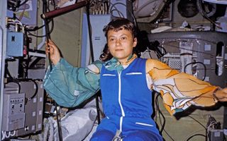 Svetlana Savitskaya wearing a colorful flight suit with one orange arm and one blue.