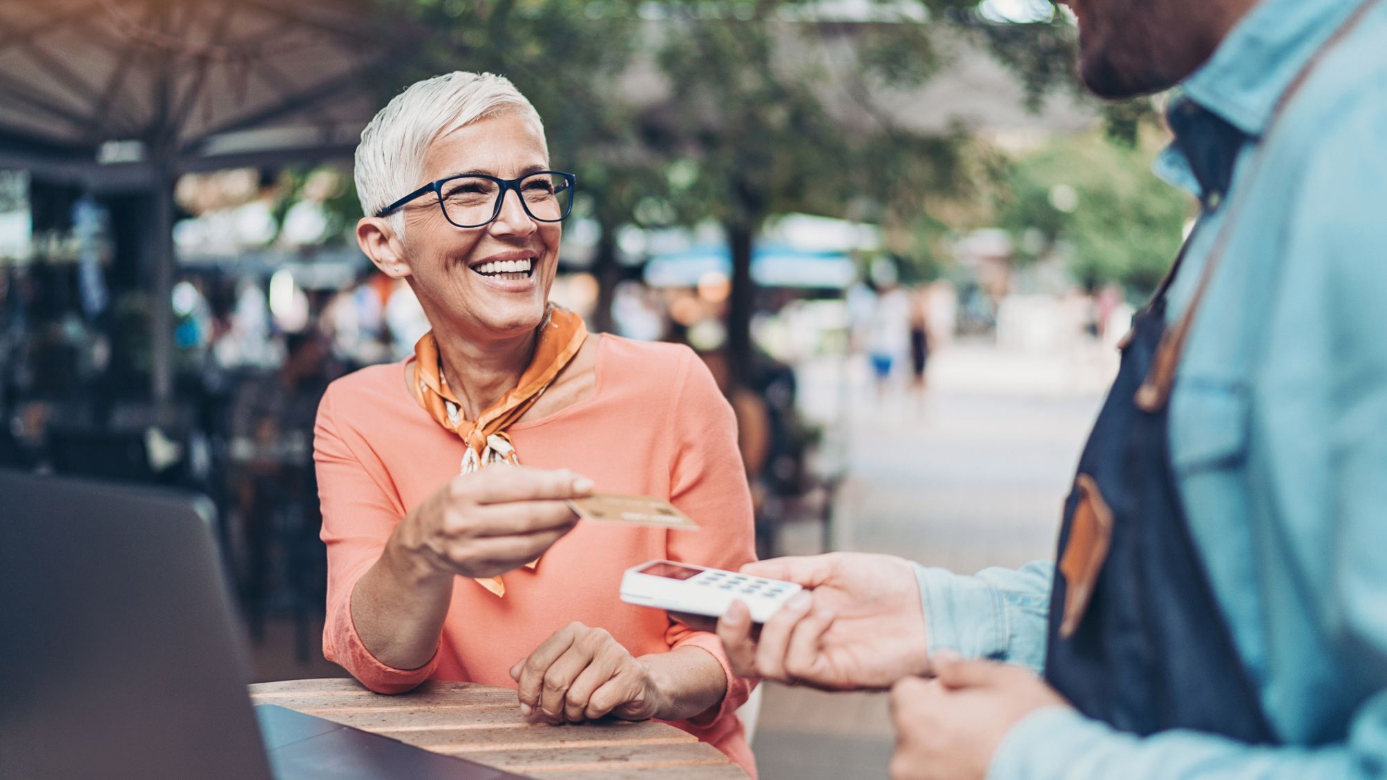 A woman paying for lunch with a credit card