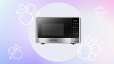Microwave with soap bubbles on pastel background