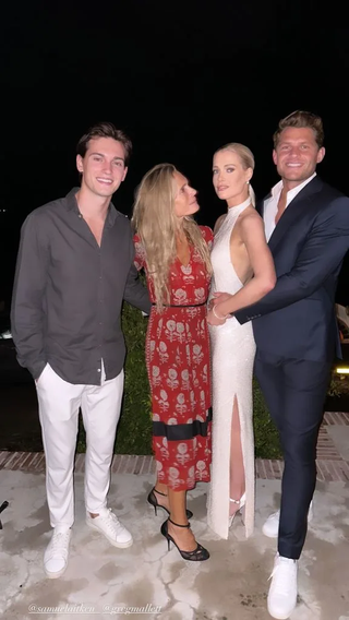 Amelia Spencer wearing a white sequin dress and Greg Mallett wearing a blue suit with white sneakers posing with Victoria Lockwood and Samuel Aitken