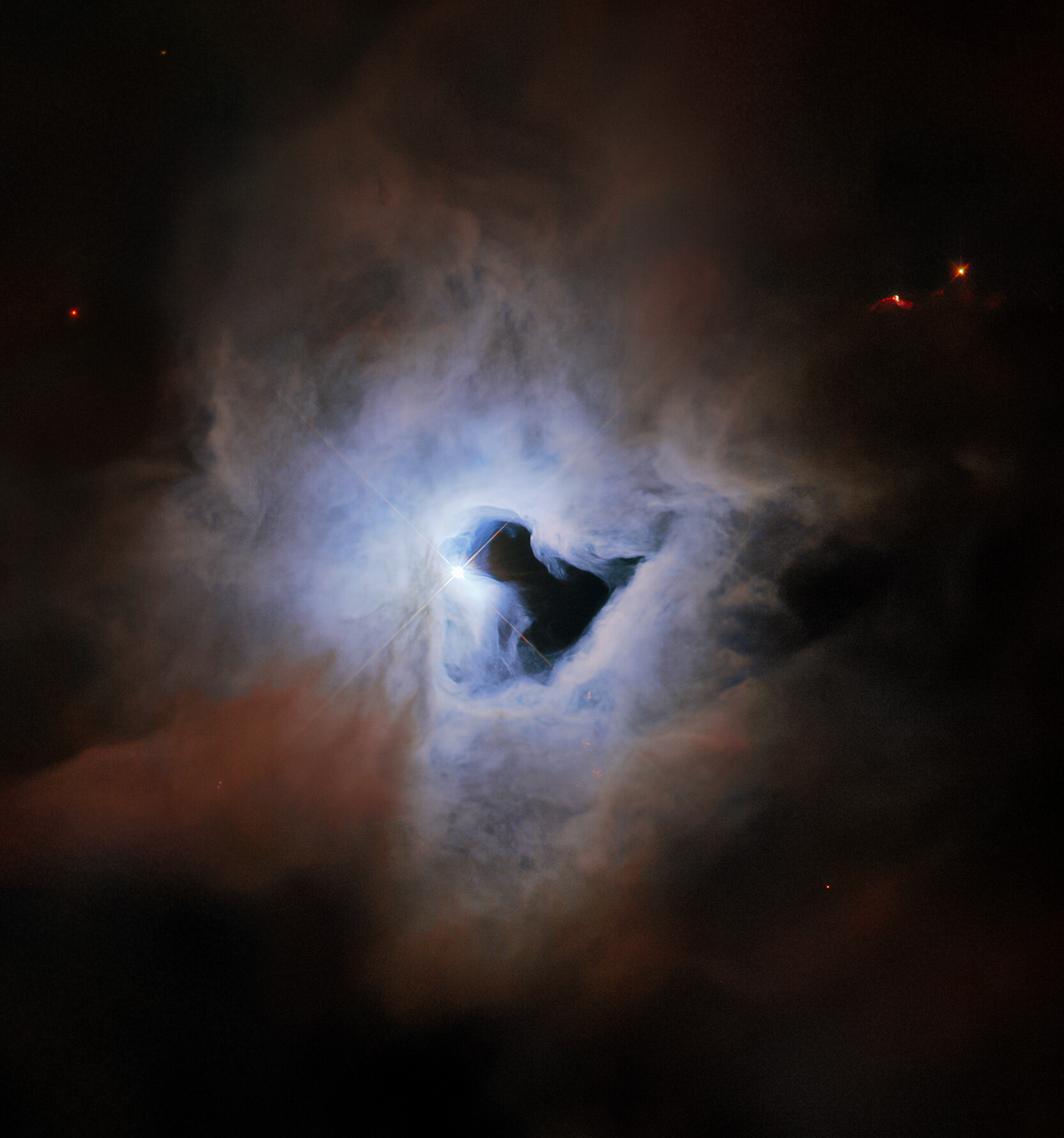 This peculiar portrait from the NASA/ESA Hubble Space Telescope showcases NGC 1999, a reflection nebula in the constellation Orion.