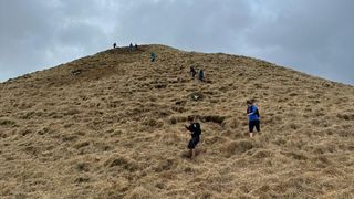 A group of women runners making their way down a mountain