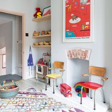 play room with grey wall and chairs with toys