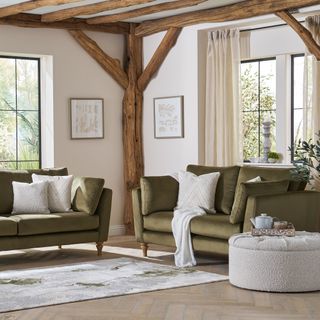 Two green sofa with cream cushions in farmhouse style living room