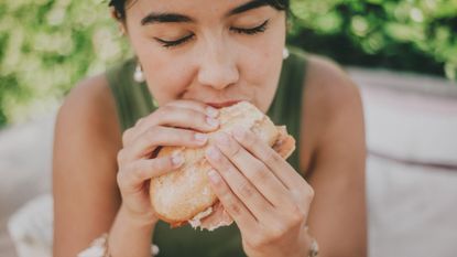 Woman eats a high-protein sandwich