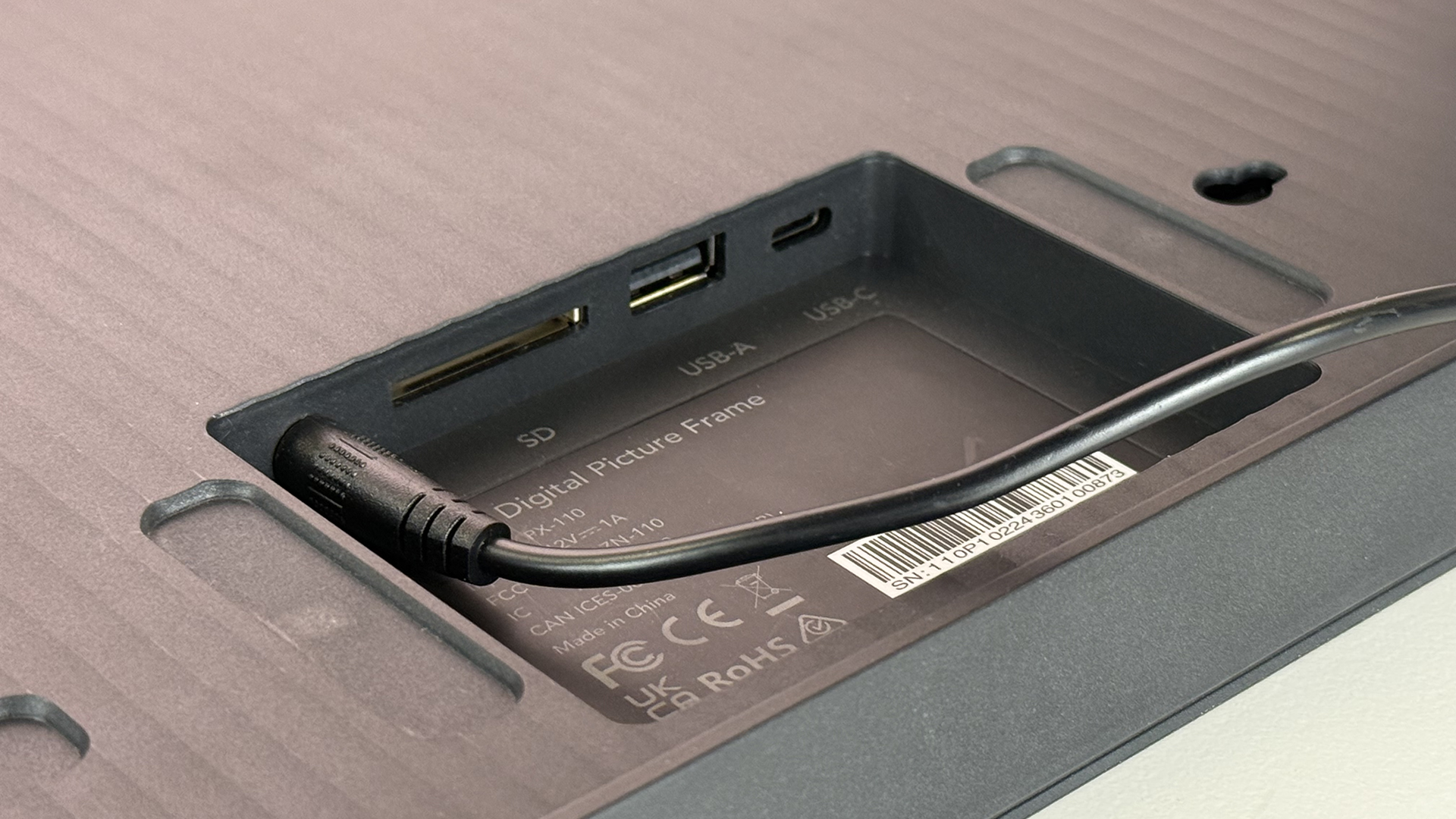 A close-up of the rear of the Pexar 11-inch Digital Picture Frame showing its power, SD, USB and USB-C ports.