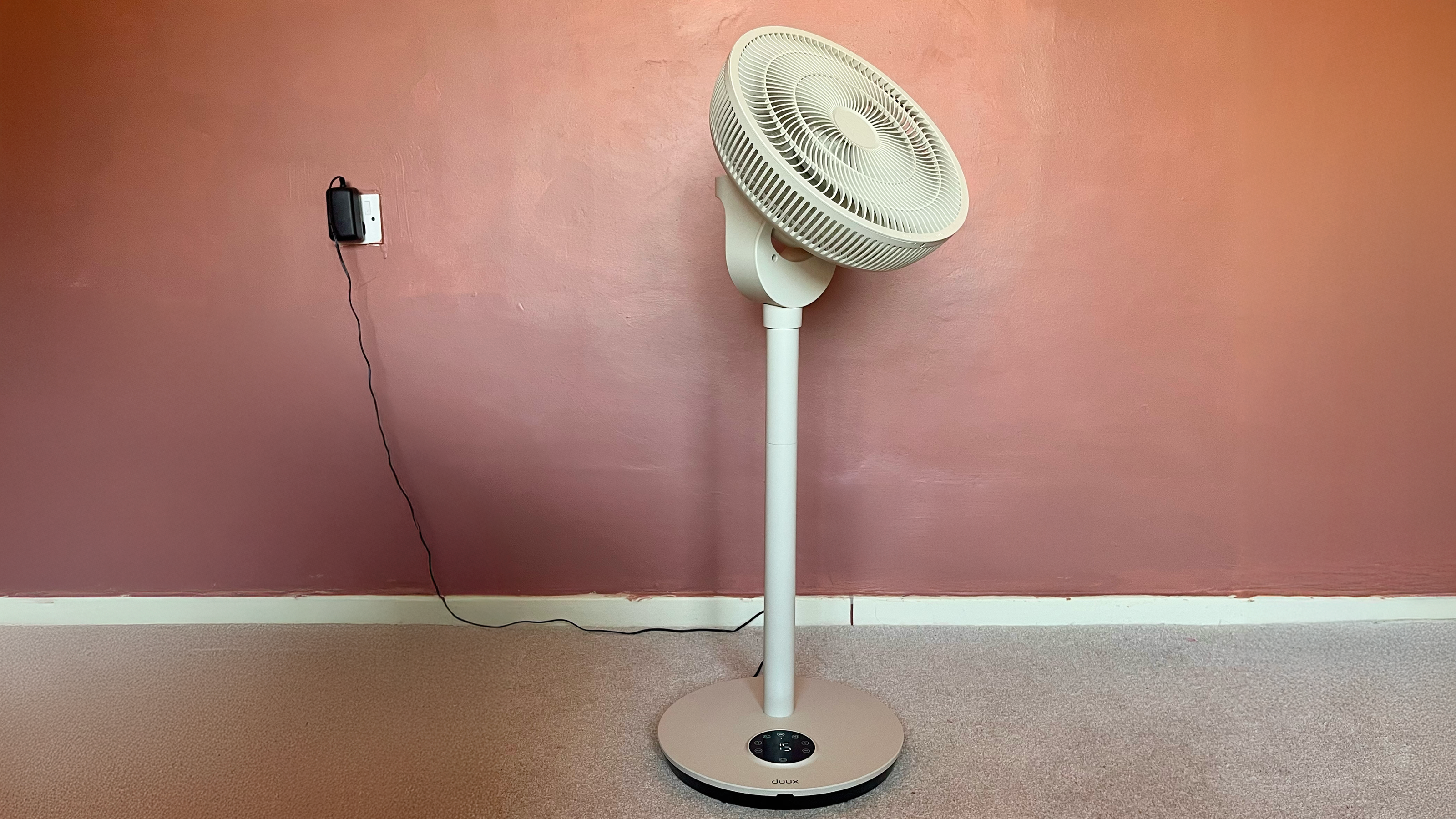Duux Whisper Flex 2 fan on a pink background