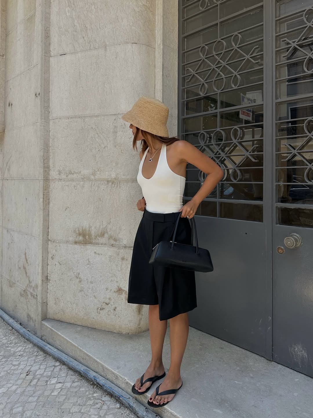 Debora wearing long shorts and a baguette bag