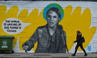 A mural in Dublin of Greta Thunberg, who is pictured saying 'the world is waking up and change is coming'