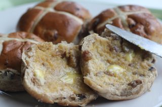 In the 12th century an Anglican monk baked the buns and marked them with a cross in honor of Good Friday. they became a symbol of Easter weekend.