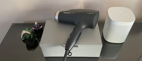 The Panasonic EH-NA67 hair dryer lying on a jewellery box on a dressing table