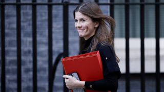 Michelle Donelan walking with a red briefcase in Downing Street