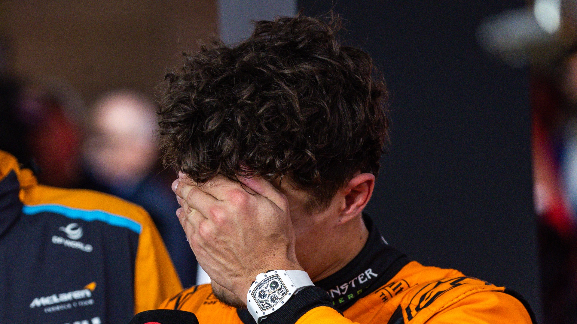 Lando Norris covering his face in the aftermath of the Qatar Grand Prix in 2024