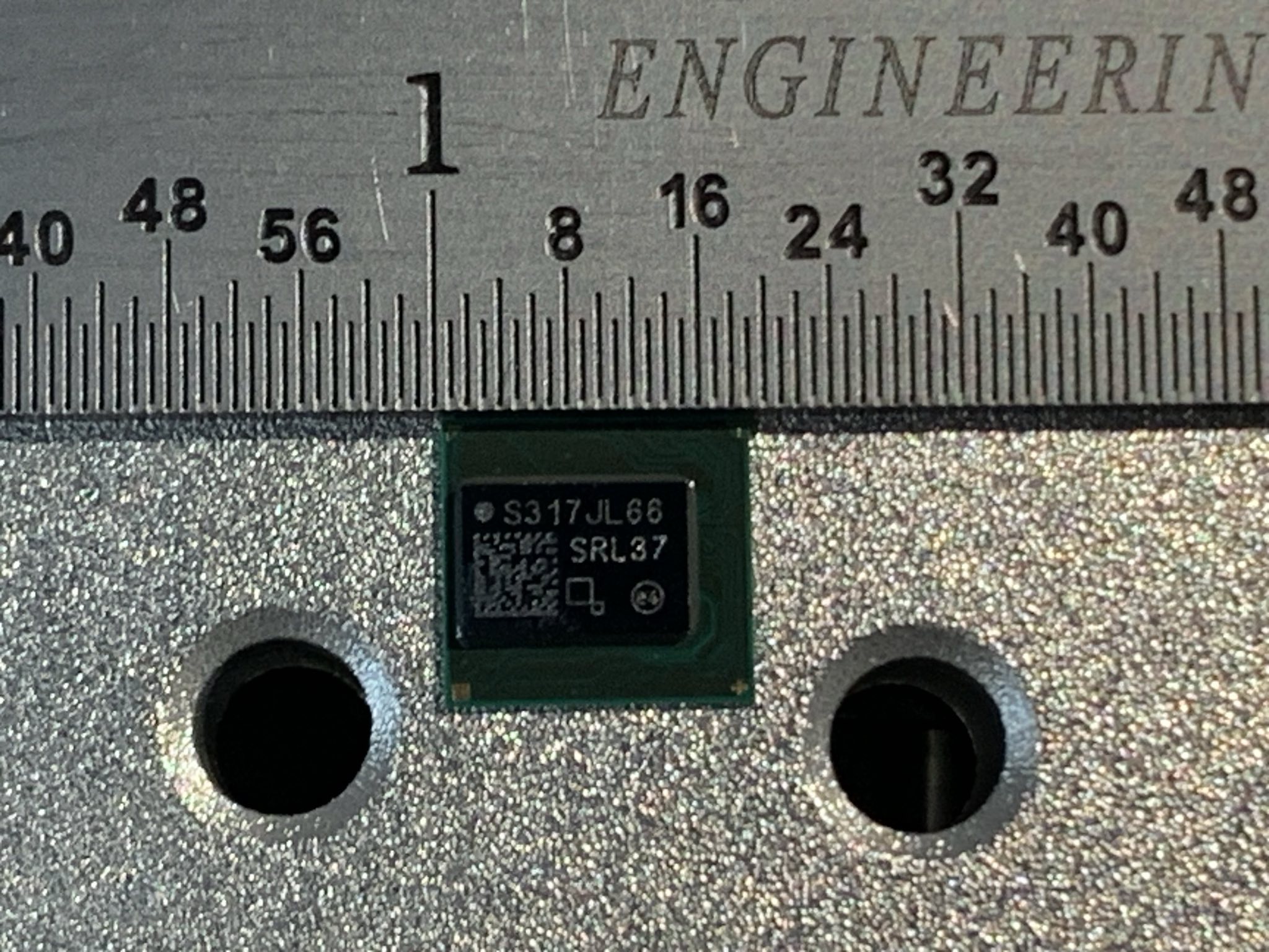 An Intel BZM2 ASIC measured against a ruler.