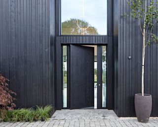 Black front door and black cladding, converted barn