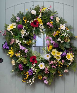 spring wreath on door with faux flowers from Whitefields Decor