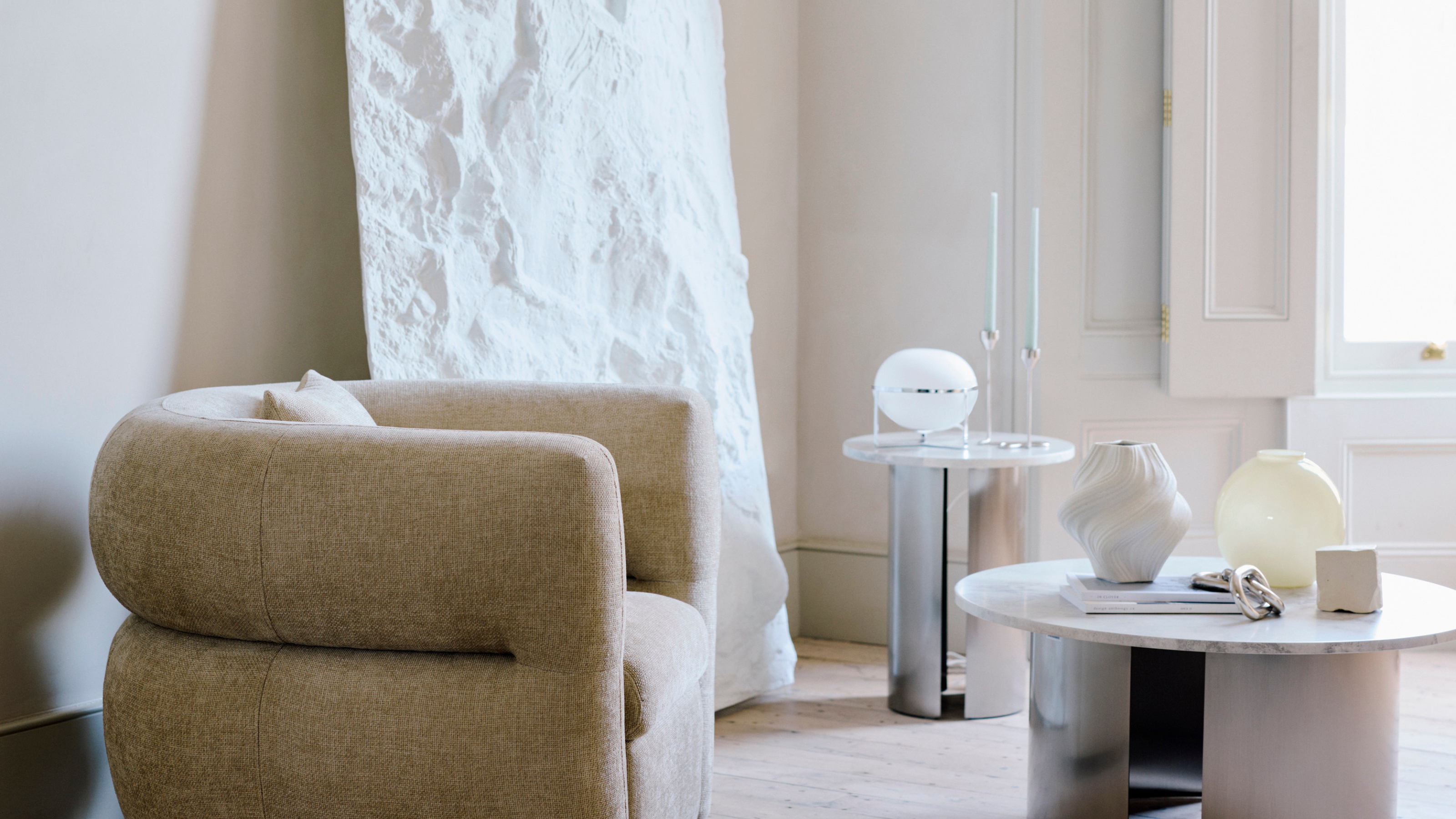 Very chrome lamp in neutral living room.