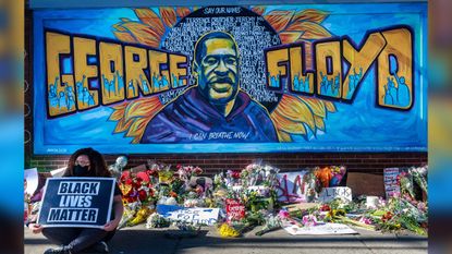 Flowers, signs and balloons are left near a makeshift memorial to George Floyd near the spot where he died while in custody of the Minneapolis police, on May 29, 2020, in Minneapolis, Minnesota.