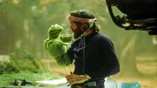 A screenshot of the promotional image for Jim Henson: Idea Man, which shows the iconic puppeteer looking at Kermit the Frog
