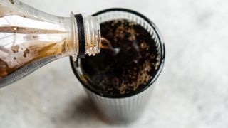 Coca cola being poured into a glass