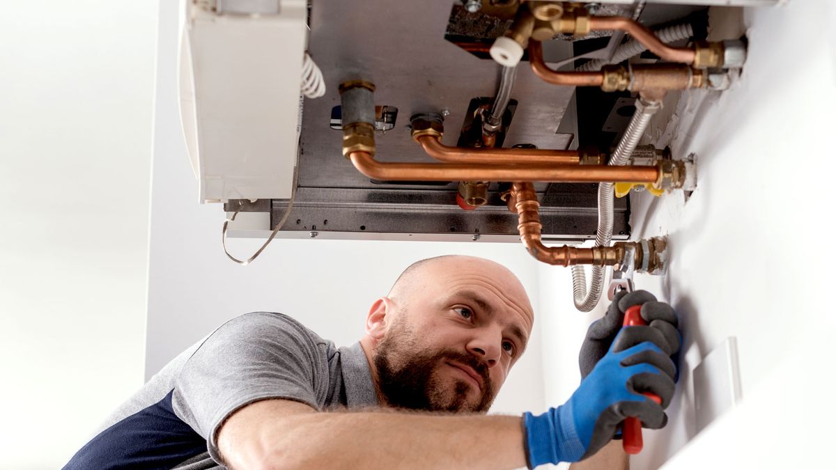 Man installing combi boiler