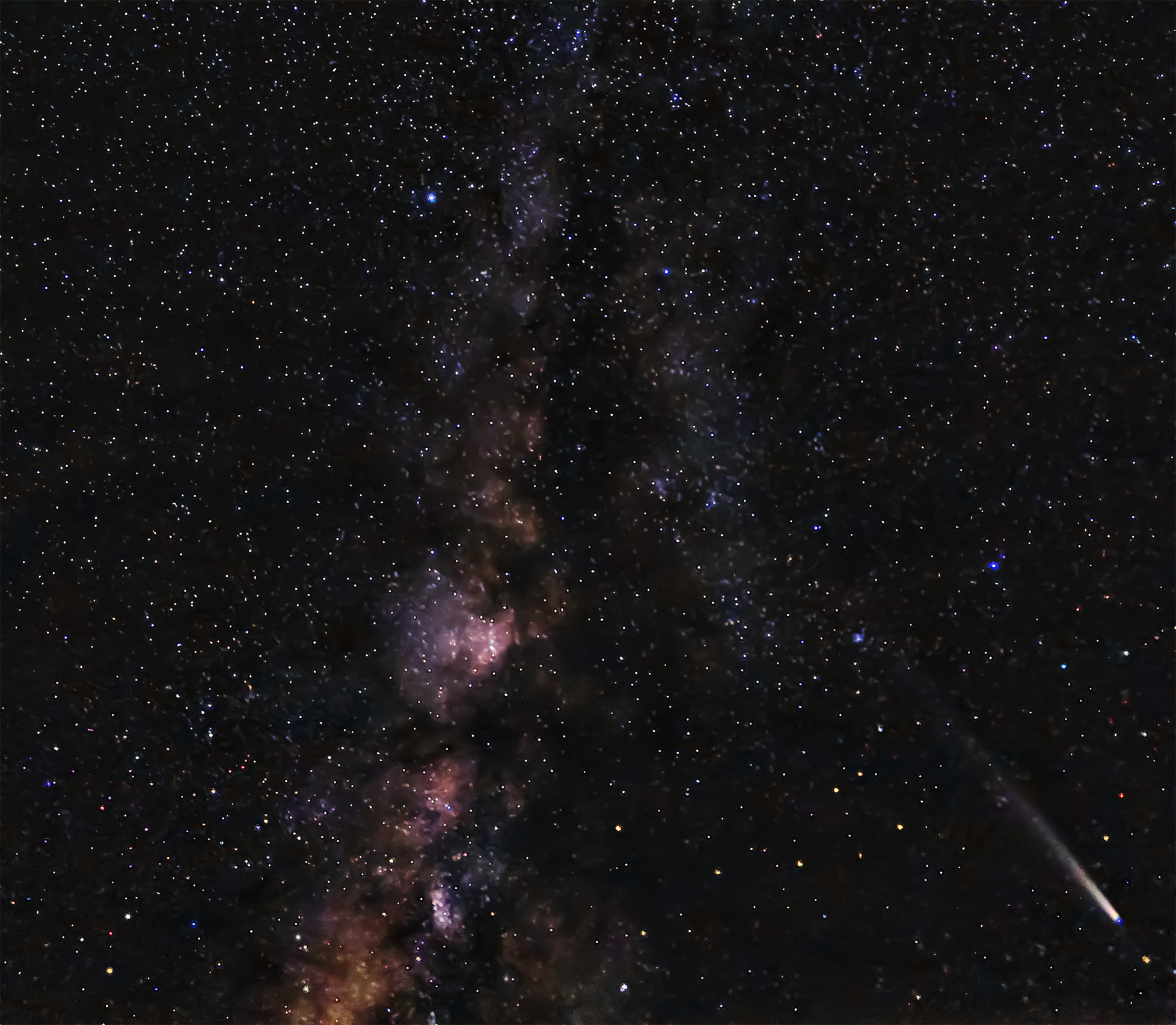 A stunning night sky filled with countless stars, featuring the Milky Way&#039;s colorful band and a bright comet streaking across the scene