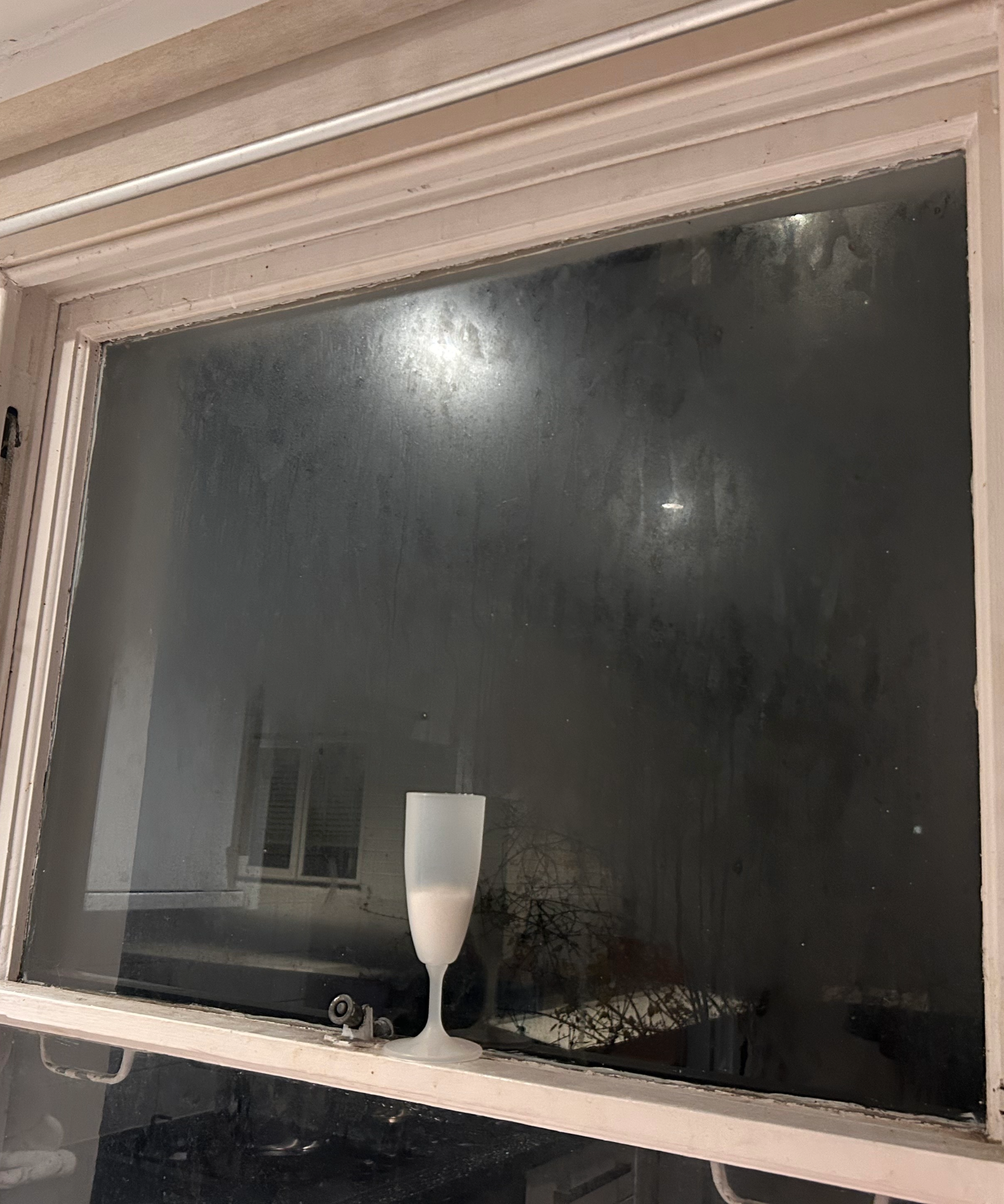 Glass on window sill with condensation