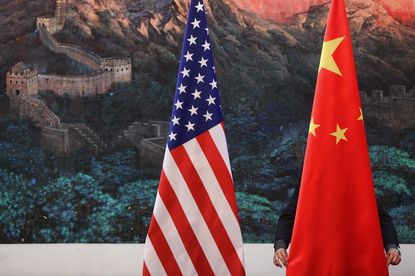 The Chinese flag sits next to the American flag