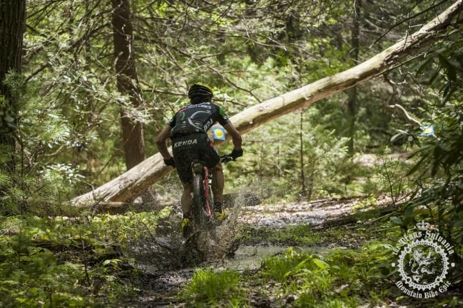 Drew Edsall hits a muddy puddle before a log-und er on Stage 2
