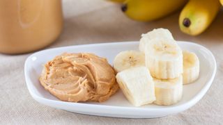 Peanut butter and sliced banana on a plate