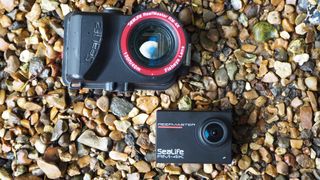 SeaLife ReefMaster RM-4K waterproof camera on a stony waterside
