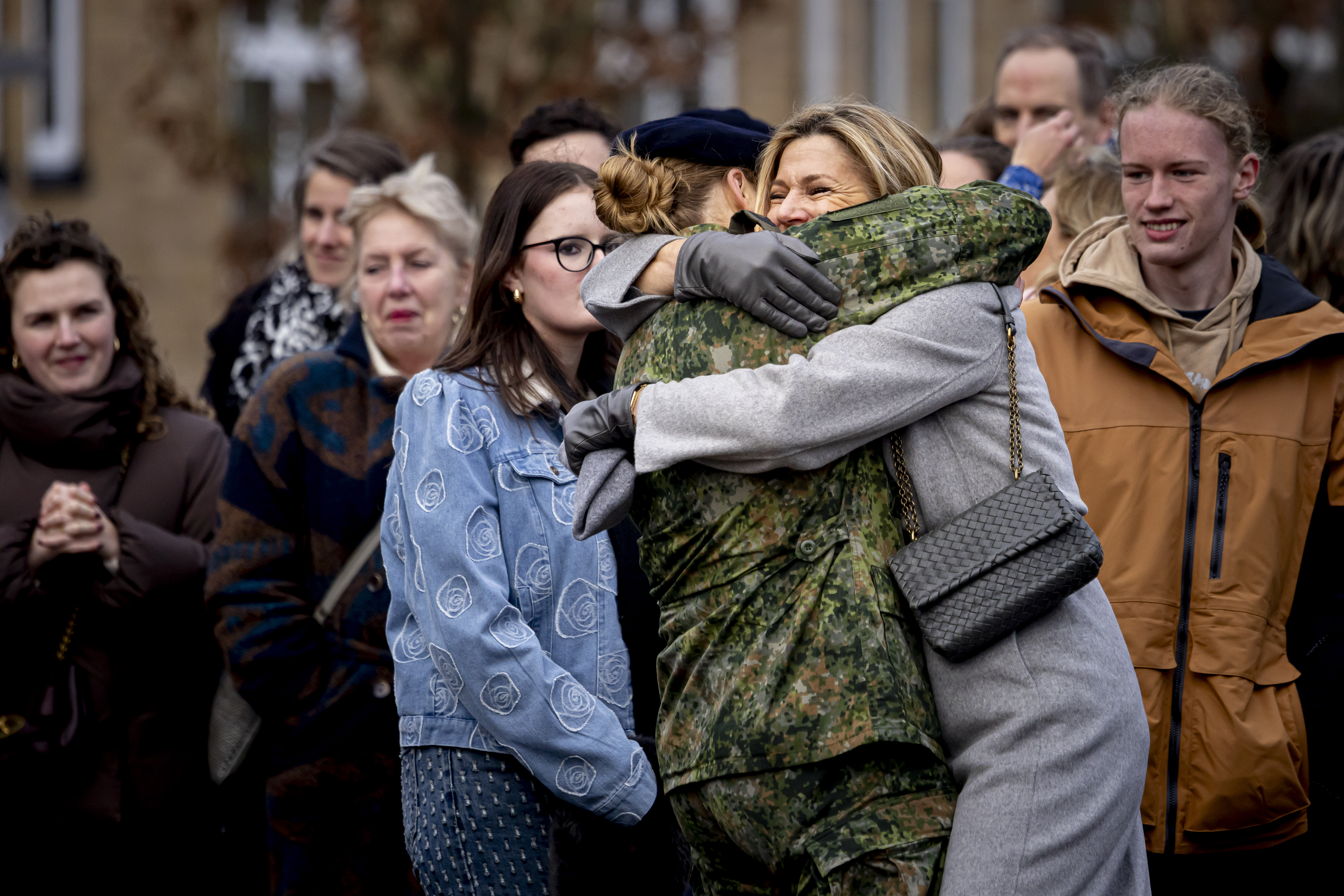 Queen Maxima hugging Princess Catharina-Amalia in a military uniform
