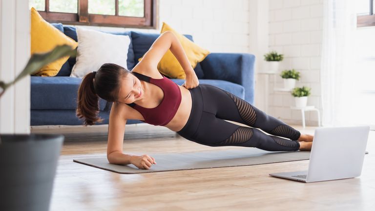 Woman doing a side plank home workout