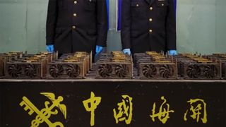 An image showing Chinese custom officials with a haul of RX 580 graphics cards.