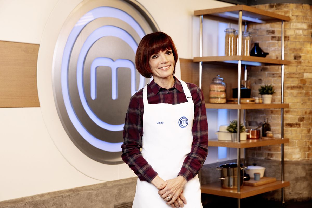 Diane Carson standing in the Celebrity MasterChef kitchen, wearing her MasterChef apron and smiling at the camera